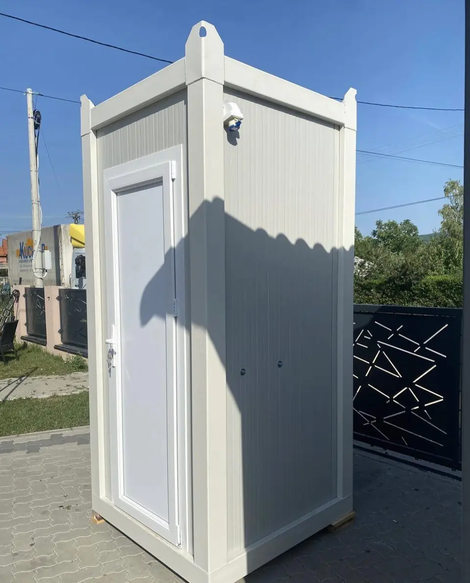 Side view of a white deluxe restroom cabin