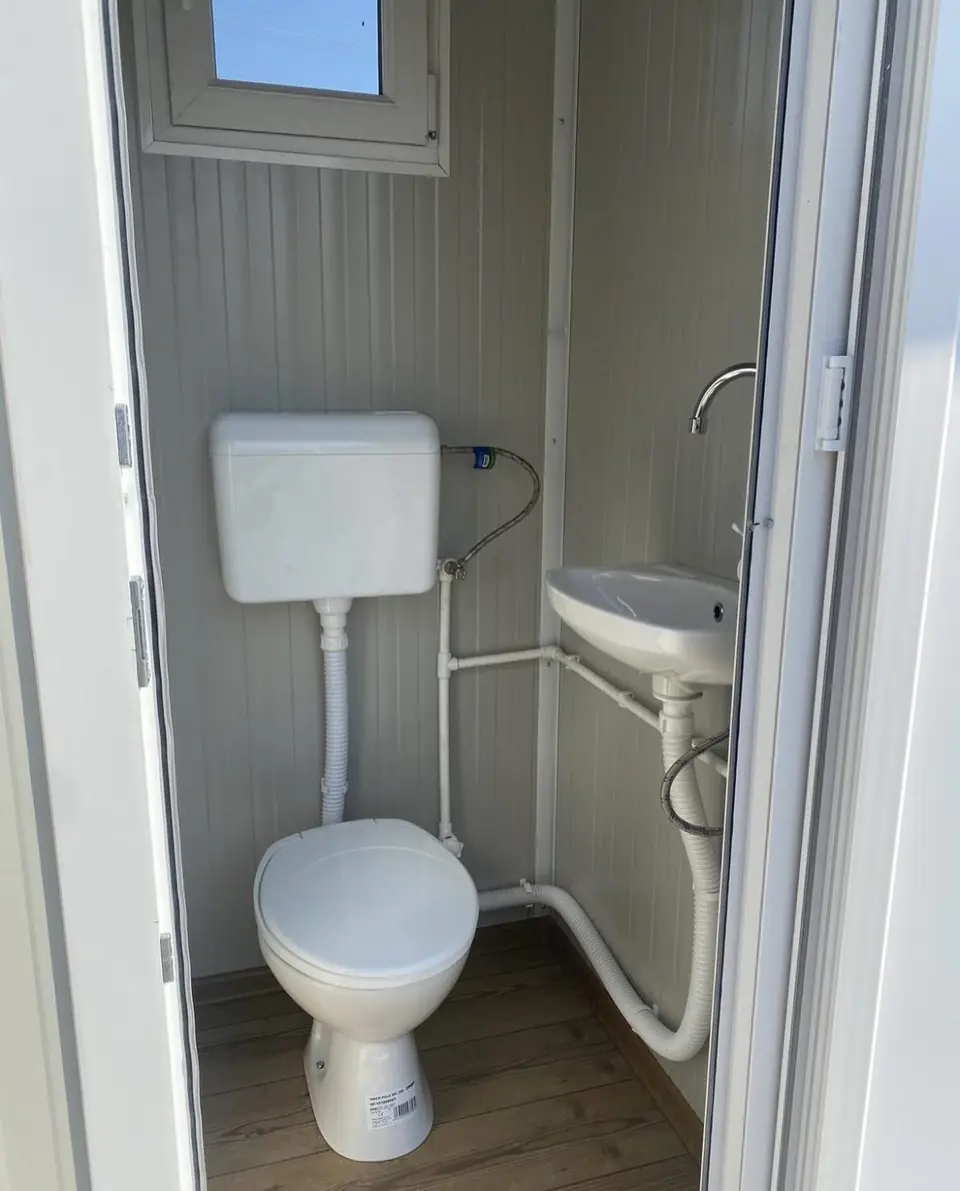 Inside a deluxe flushing unit with toilet and sink